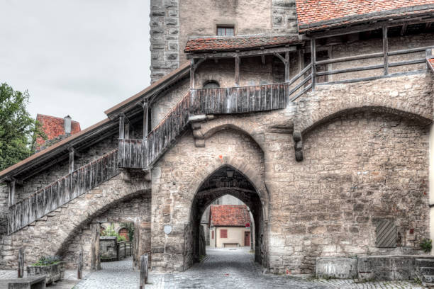 A battlement in the old city wall with city gate of the historic old town of Rothenburg ob der Tauber