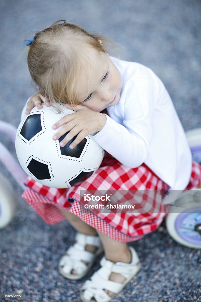 Girl with ball Outdoors portrait of adorable little girl with a ball Casual Clothing Stock Photo