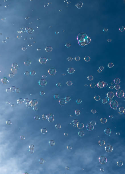 istock Numerous Colorful Soap Bubbles Float In Mid-Air In Front Of Blue Sky 1489735734