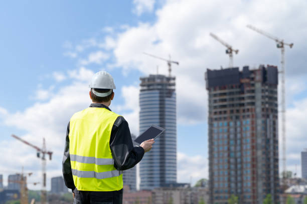 istock Engineer with a digital tablet on the background of construction 1489741148