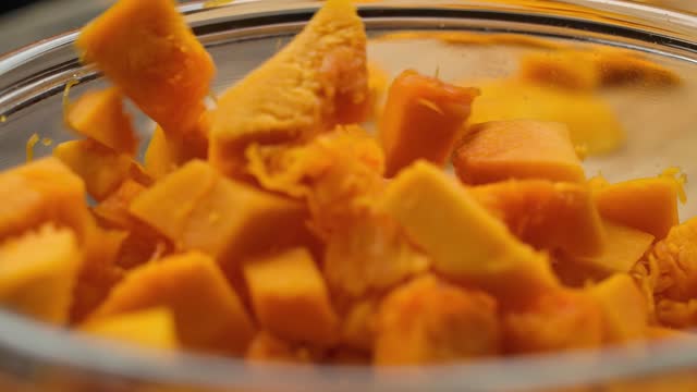 Pumpkin cut into small pieces poured into a bowl