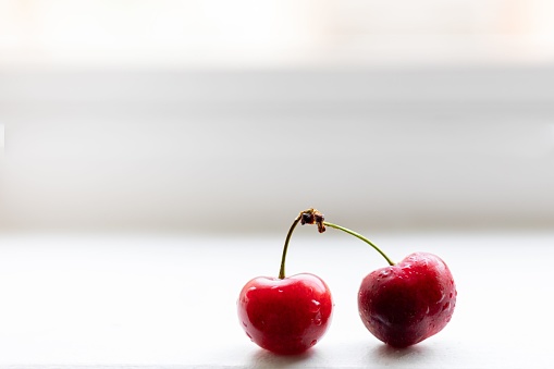 A pair of red cherries isolated on a white background
