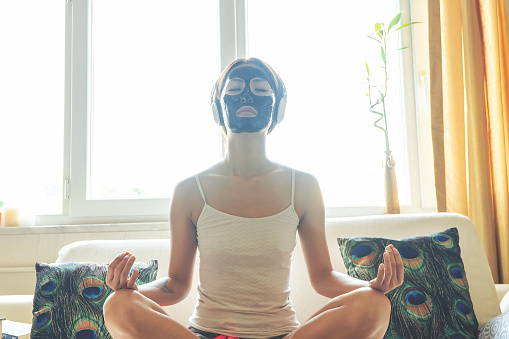 Applying facial mask - beauty product - charcoal facial mask