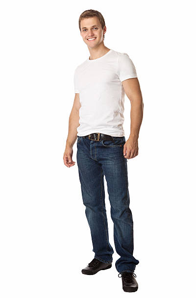 Cute young man in jeans and t-shirt looking at camera stock photo