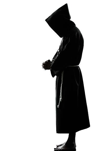 istock man monk priest silhouette praying 148975912