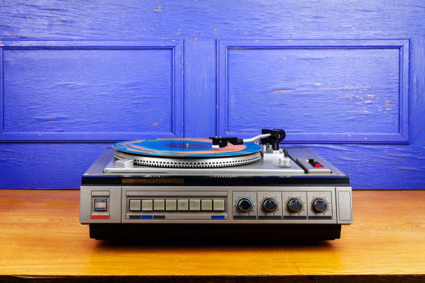 istock Vintage turntable vinyl record player with blue and orange vinyl 1489763868