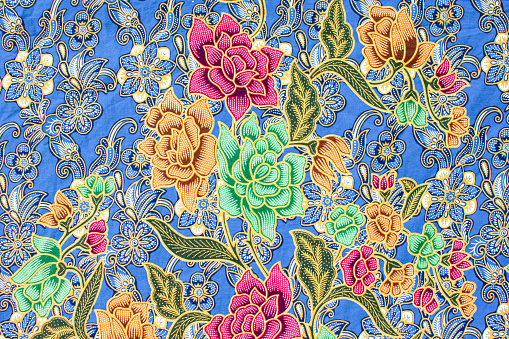 The sarong pattern for females is a beautiful and colorful art in Malaysian, Indonesian, and Thailand. Sarong texture art flowers and fashion for women in Asia. Close up photo, landscape background.