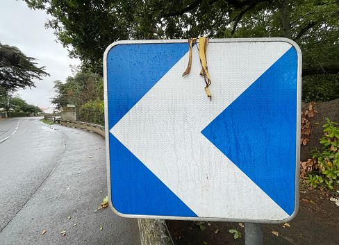 Banana skin hanging from a road sign in France
