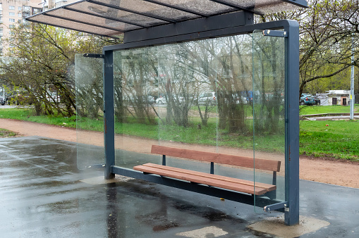Empty bus stop complex on a rainy day
