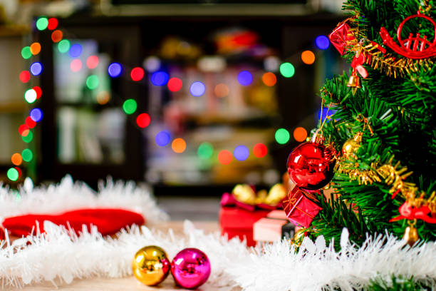 istock The green Christmas tree decorated with small bulbs is a beautiful bokeh. Christmas tree decoration with white, red, golden balls, Close-up a photo, copy space for design, blurred wooden background. 1489767101