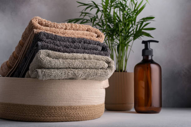 Folded fluffy cotton towels in basket