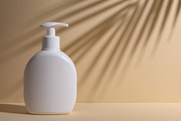 istock White blank cosmetic  bottle with shadow of palm leaves 1489772219
