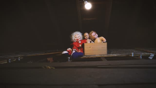 Lightbulb Swinging Around Box of Old Creepy Dolls in Attic