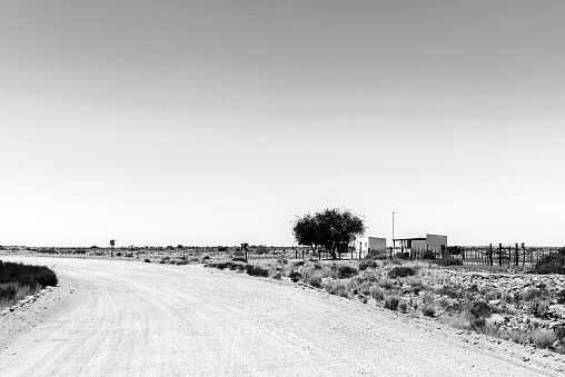 Kenhardt, South Africa - Feb 28 2023: Farm worker houses at Rugseer on road R383 between Kenhardt and Putsonderwater in the Northern Cape Province. Monochrome