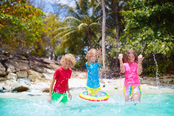 istock Kids playing on tropical beach. Summer fun. 1489779916