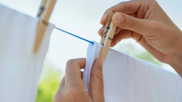 istock Woman hands hangs laundry on clothesline 1489780408