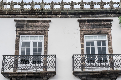 Ornate window on white façade in the city of Ponta Delgada, Sao Miguel, Azores