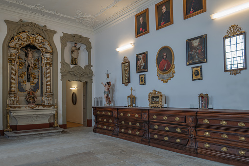 Porto, Portugal - April 19, 2023: Paintings  and sacred sculptures in the sacristy of the Dos Clericos church