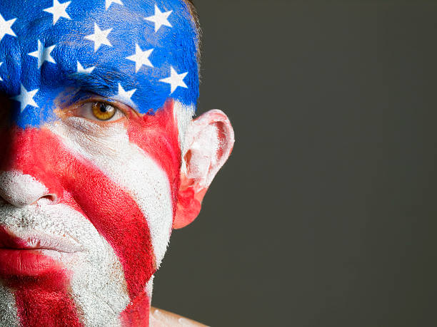 istock Man face painted with the flag of USA, sad expression 148978535