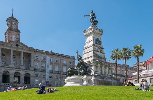 Porto, Portugal - April 19, 2023: People enjoy the sun in Do Infante square under  the monument of the Prince Henry