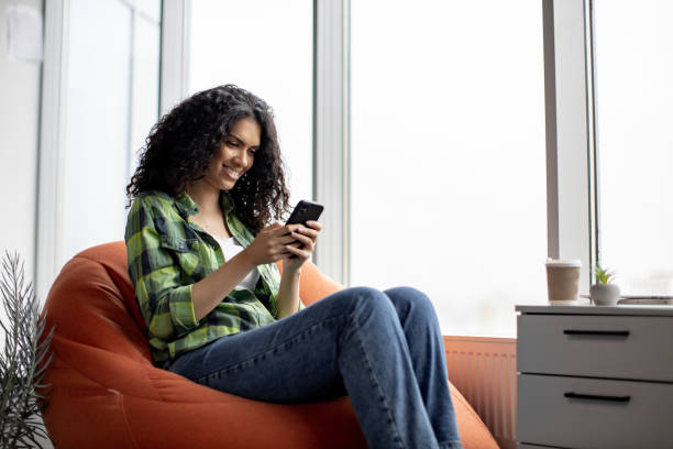 istock Woman chatting with colleagues via cell phone in office 1489786477