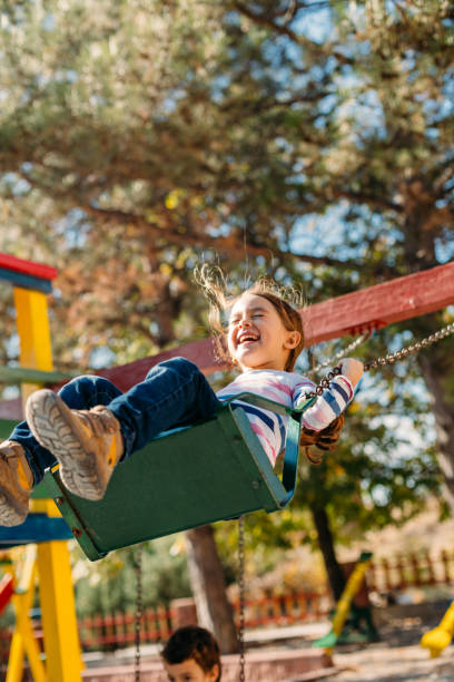 istock Happy children swinging in the park 1489786508