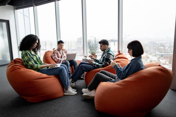 istock Multicultural teammates holding gadgets in coworking space 1489786516