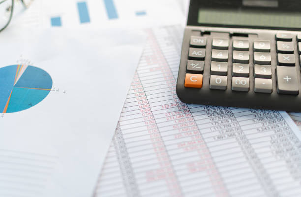 istock financial accounting, work from home, closeup calculator on desktop, check account number on paper and calculator, lots of numbers, graph, glasses on paper, blurry background 1489786826