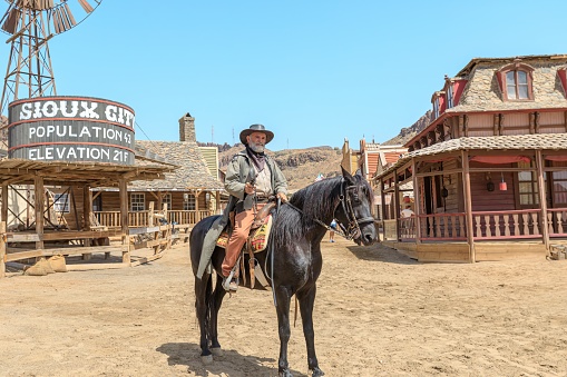 Gran Canaria - April 2023: Feel like true cowboy or Indian the moment you step into our theme park. Stroll through the town and witness a thrilling bank robbery while the sheriff takes on real outlaws