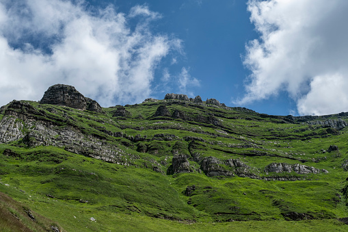 Karst landforms in green steep mountain slope
