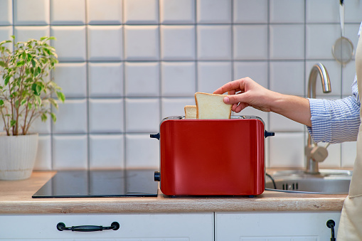 Modern red toaster for cooking toasts