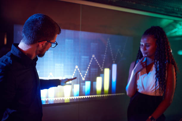 istock Man and woman, project leaders showing presentation on digital screen, graphs and analytics. Modern technologies 1489793063