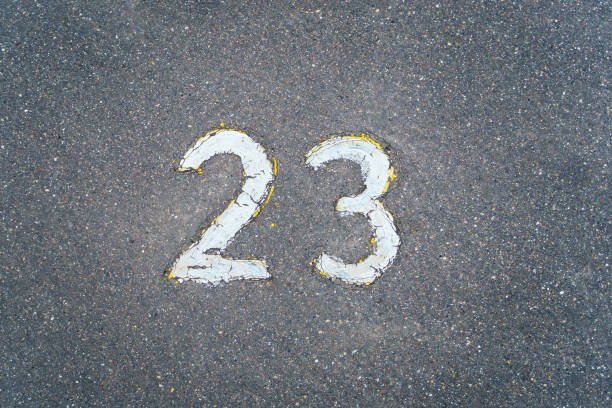 istock The number 23 written in white paint on the asphalt 1489795121