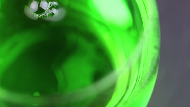 Green carbonated drink with gas on the table