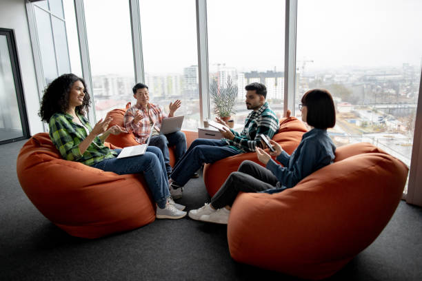 istock Multicultural teammates holding gadgets in coworking space 1489795653