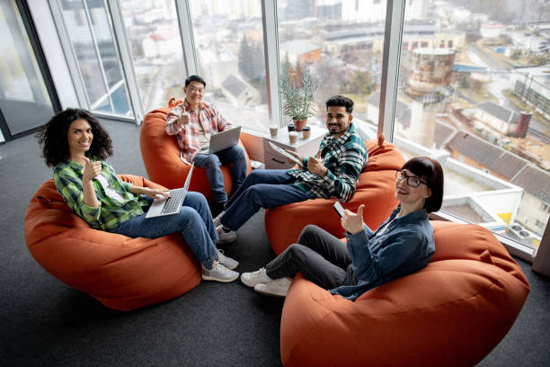 istock Males and females posing with gadgets in shared workspace 1489795693