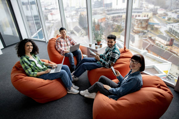 istock Males and females posing with gadgets in shared workspace 1489795767