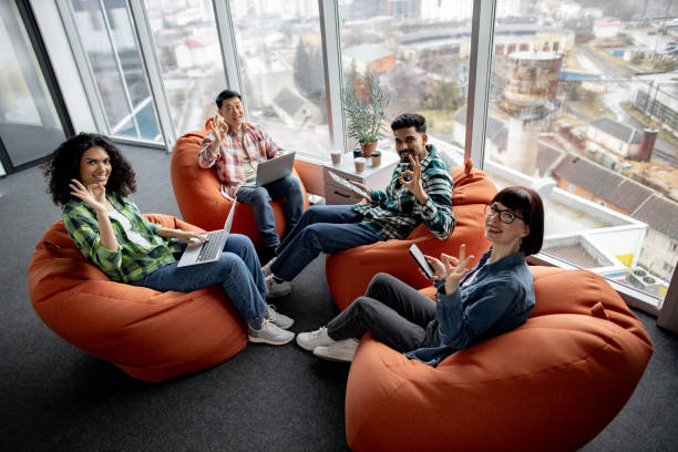 istock Males and females posing with gadgets in shared workspace 1489795802