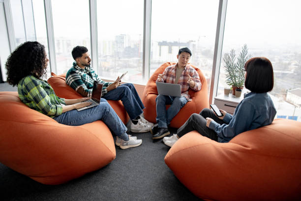 istock Businesspeople holding mobile gadgets in coworking space 1489795840