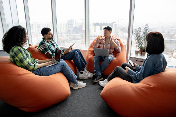 istock Businesspeople holding mobile gadgets in coworking space 1489795869