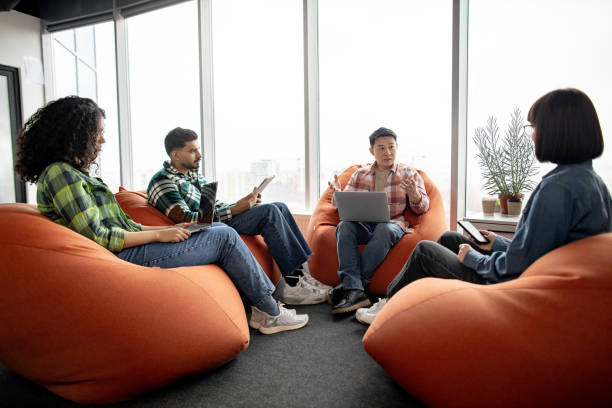 istock Businesspeople holding mobile gadgets in coworking space 1489795890