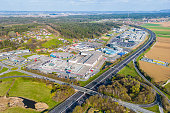 Industrial complex and commercial area beside a highway in Austria seen from the air as example for massive sealing of soil