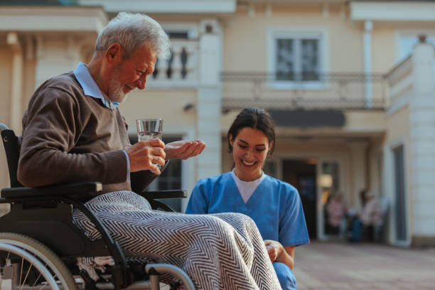 istock Cheerful elderly man taking medication in nursing home yard. 1489797474