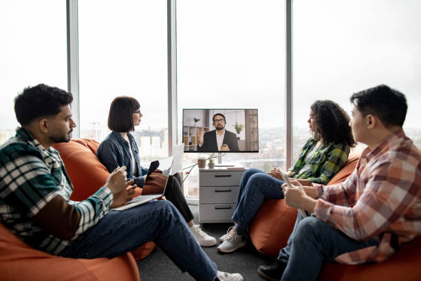 istock Employees making video call on display in office interior 1489797523