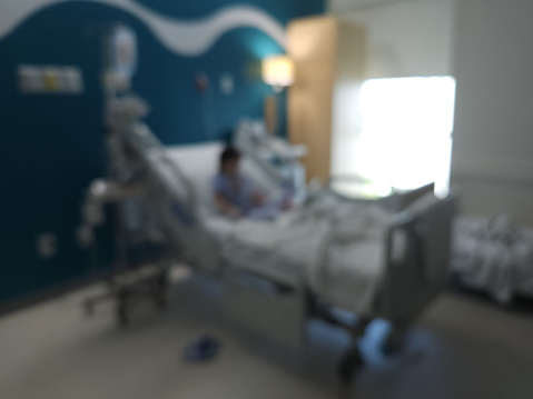 Kid in hospital bed room blurred background