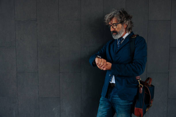 istock Trendy businessman looking at time on watch. 1489800877