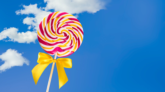 Colorful lollipop on blue background with copy space. Summer concept.