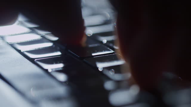 Close up hands typing on a computer keyboard