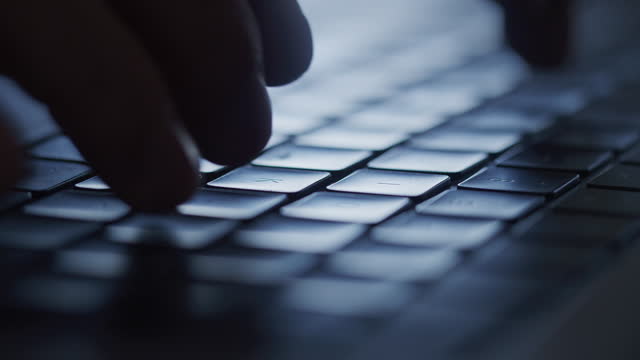 Close up hands typing an e-mail on a keyboard