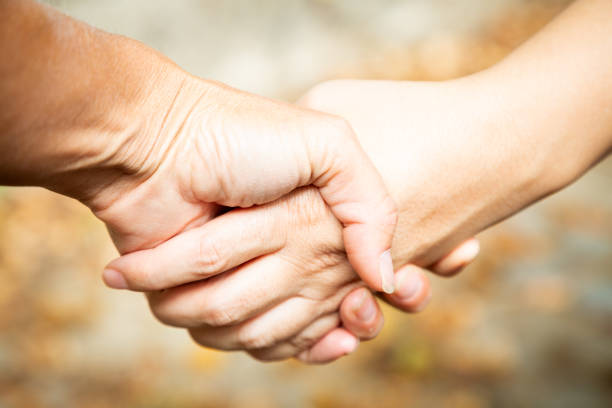 istock Two women shaking hands outdoors. Team work and agreement setting concept. Women solidarity and support. Caucasian palm. Strength and collaboration. fingers with blurred background. Make business 1489804621